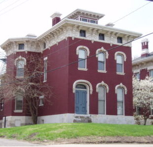 Before restoration: boarded windows and deteriorated brick on the Nelson Sanford House.
