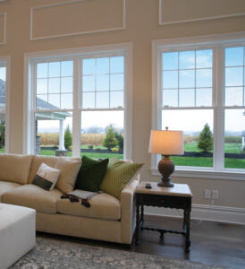 Double-hung Okna 600 windows in a cozy Midwest living room with scenic views