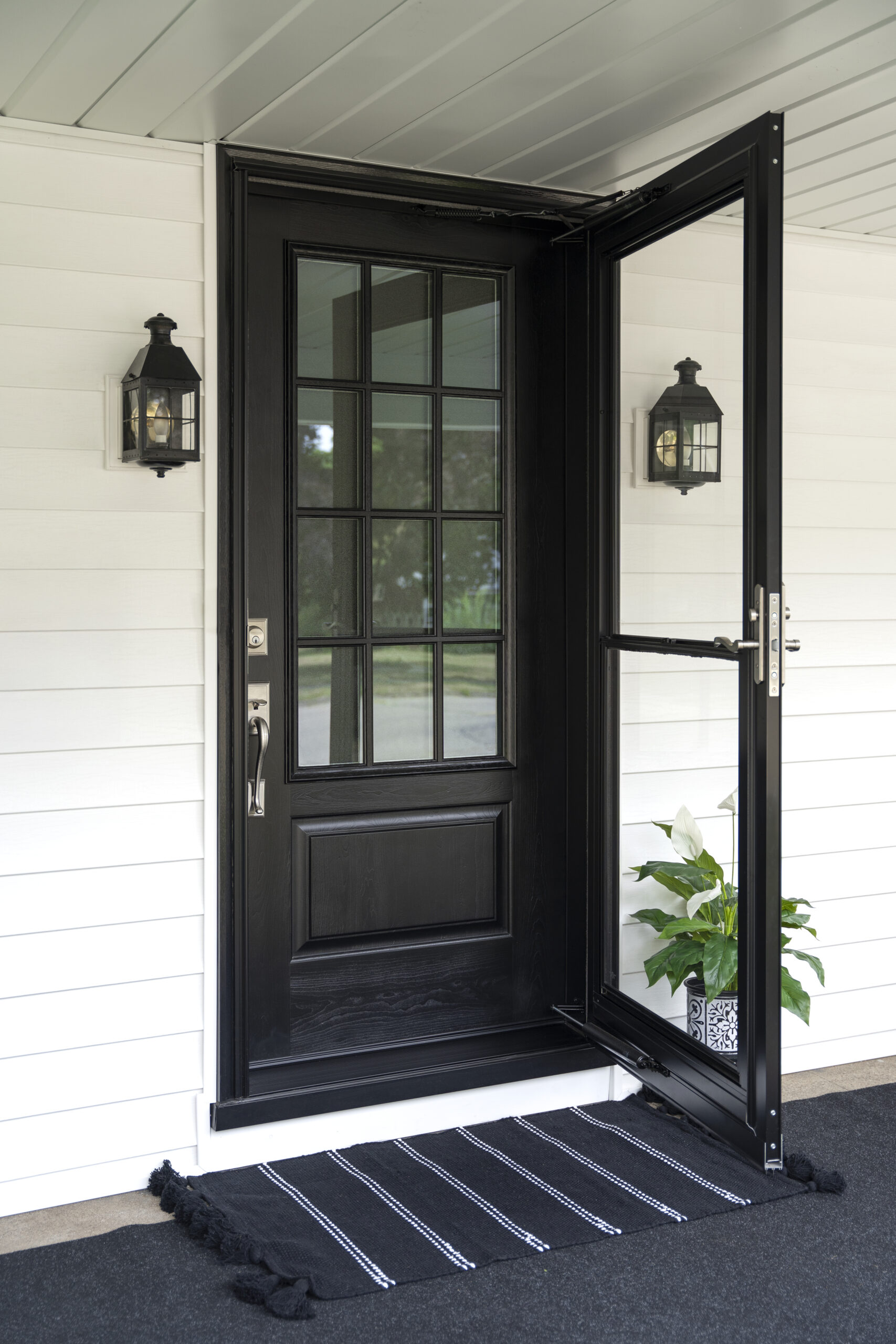 Stained ProVia Signet Cherry entry door with two sidelites and cottage-style internal grids on a white exterior