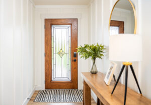 ProVia Signet Oak entry door with Aria decorative glass and caramel stain, shown in a Cleveland home interior with black Schlage hardware