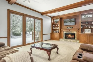 Wood laminated interior sliding vinyl patio door overlooking a snowy backyard in winter, demonstrating year-round comfort and energy efficiency.